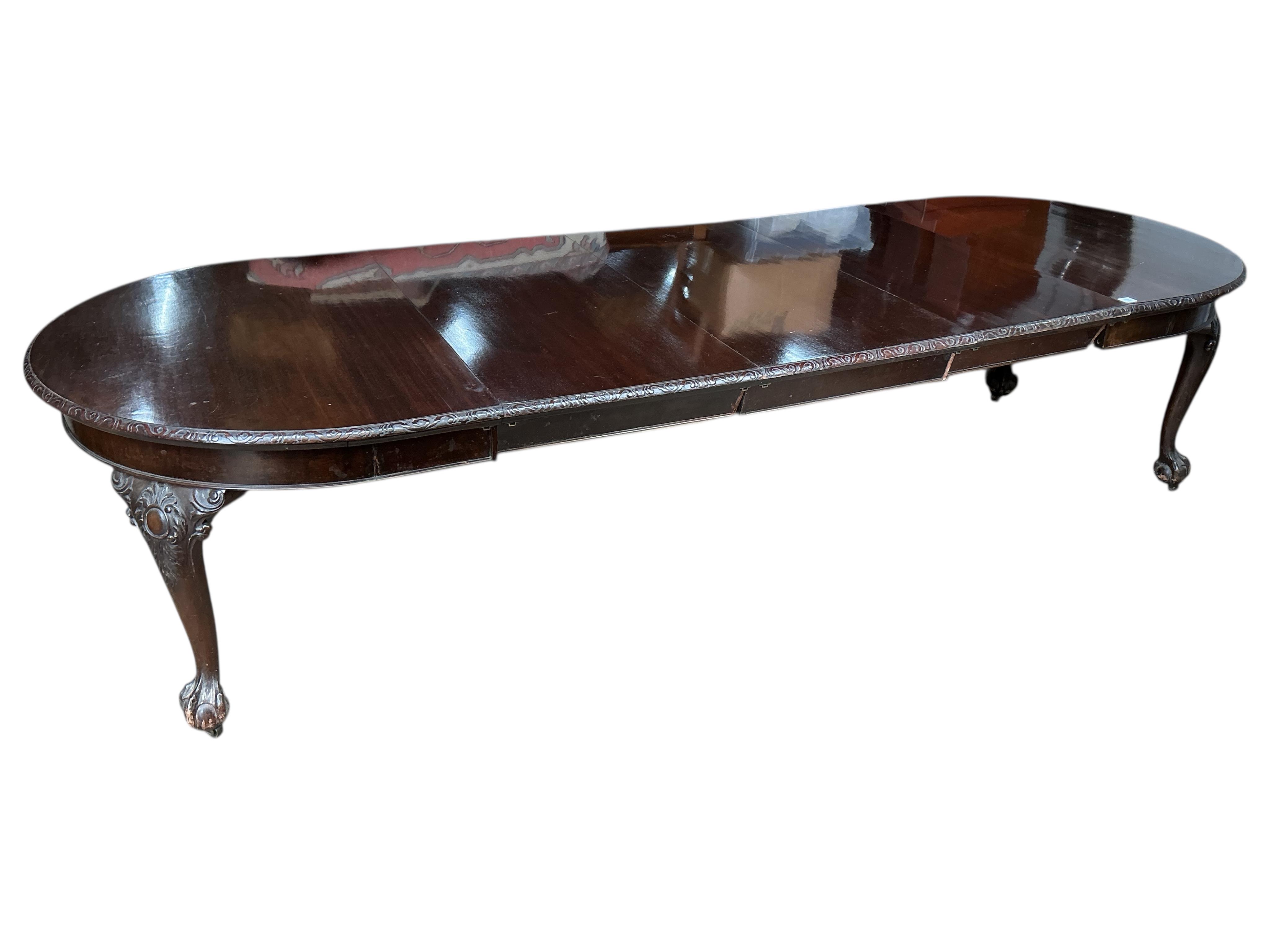 An early 20th century Chippendale Revival mahogany extending dining table, on cabriole legs with claw and ball feet, width 340cm extended, three spare leaves, depth 120cm, height 77cm